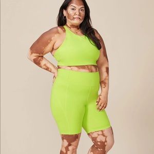 Girlfriend collective set in lime green. Topanga bra: XS, bike shorts: small